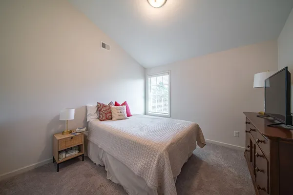 a bedroom with a bed and a flat screen tv