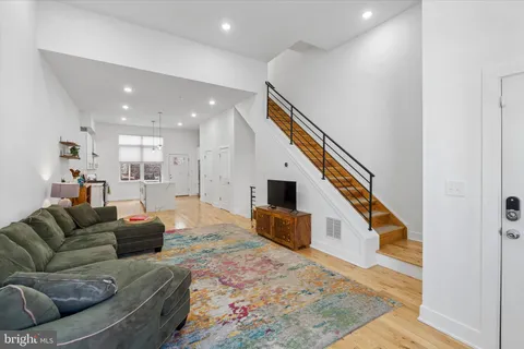a living room with furniture and kitchen view