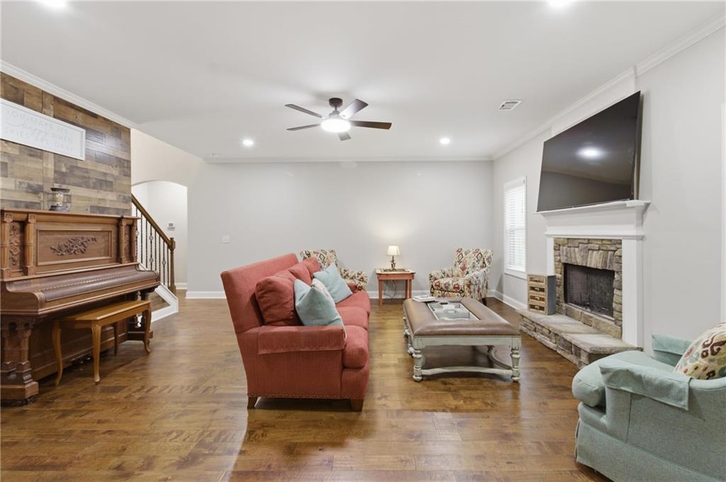 37 Farmstead Way Senoia, GA 30276 - Photo 35 of 121 a living room with furniture a fireplace and a flat screen tv