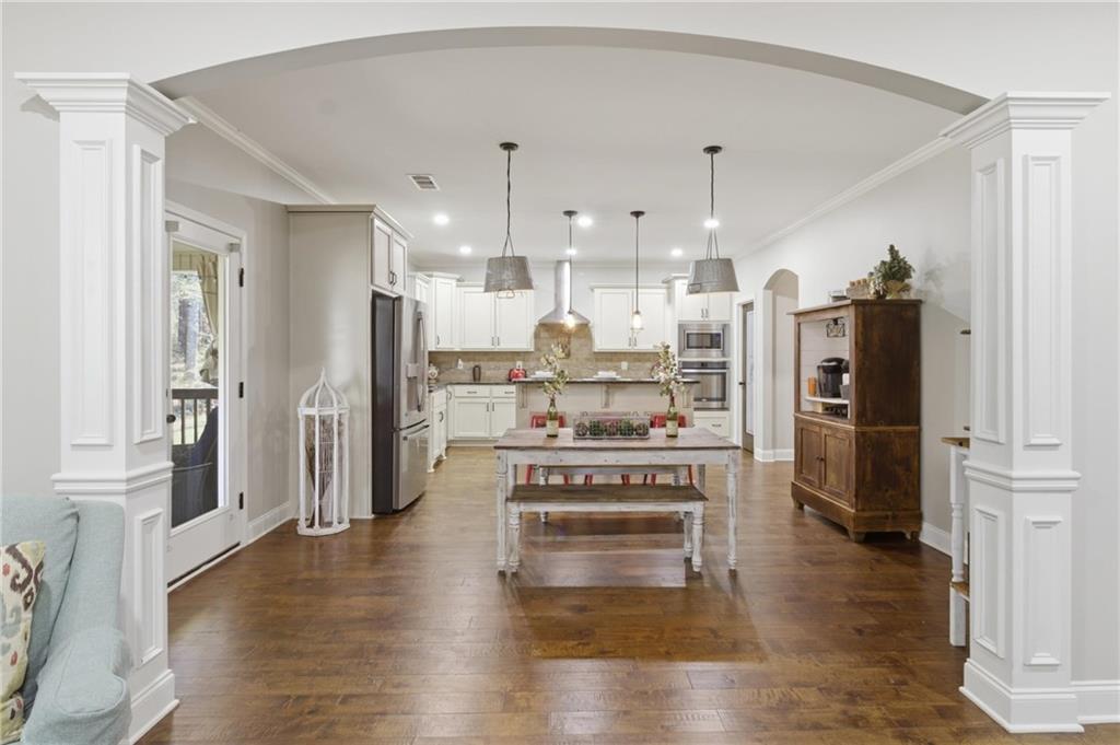 37 Farmstead Way Senoia, GA 30276 - Photo 37 of 121 a kitchen with stainless steel appliances kitchen island wooden floors and refrigerator
