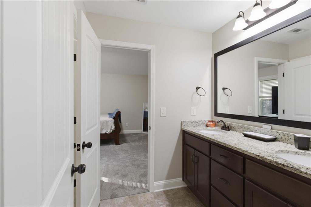 37 Farmstead Way Senoia, GA 30276 - Photo 62 of 121 a en suite bathroom with a granite countertop sink and a mirror