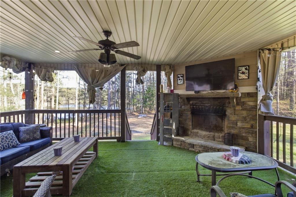 37 Farmstead Way Senoia, GA 30276 - Photo 70 of 121 a living room with furniture a flat screen tv and a fireplace