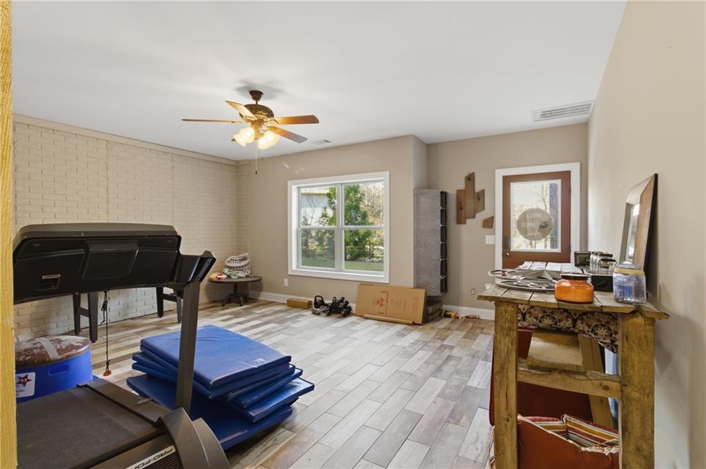 37 Farmstead Way Senoia, GA 30276 - Photo 75 of 121 a living room with furniture a flat screen tv and a window