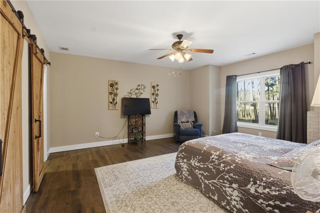 37 Farmstead Way Senoia, GA 30276 - Photo 77 of 121 a bedroom with a bed and a chandelier