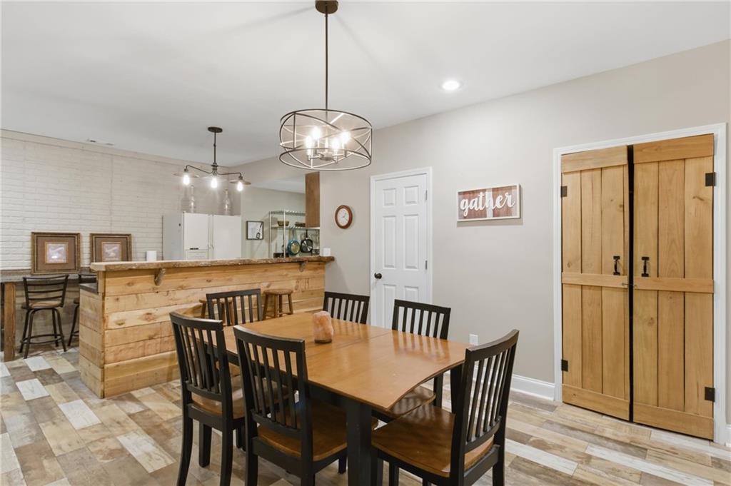 37 Farmstead Way Senoia, GA 30276 - Photo 90 of 121 a view of a dining room with furniture wooden floor and chandelier