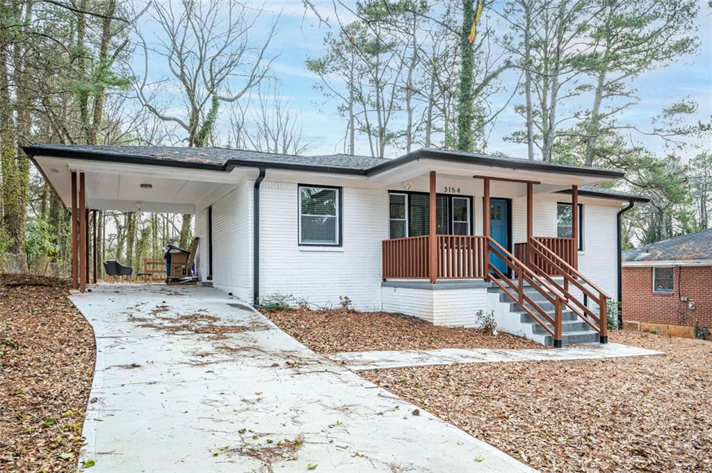 a front view of a house with a yard and wooden fence