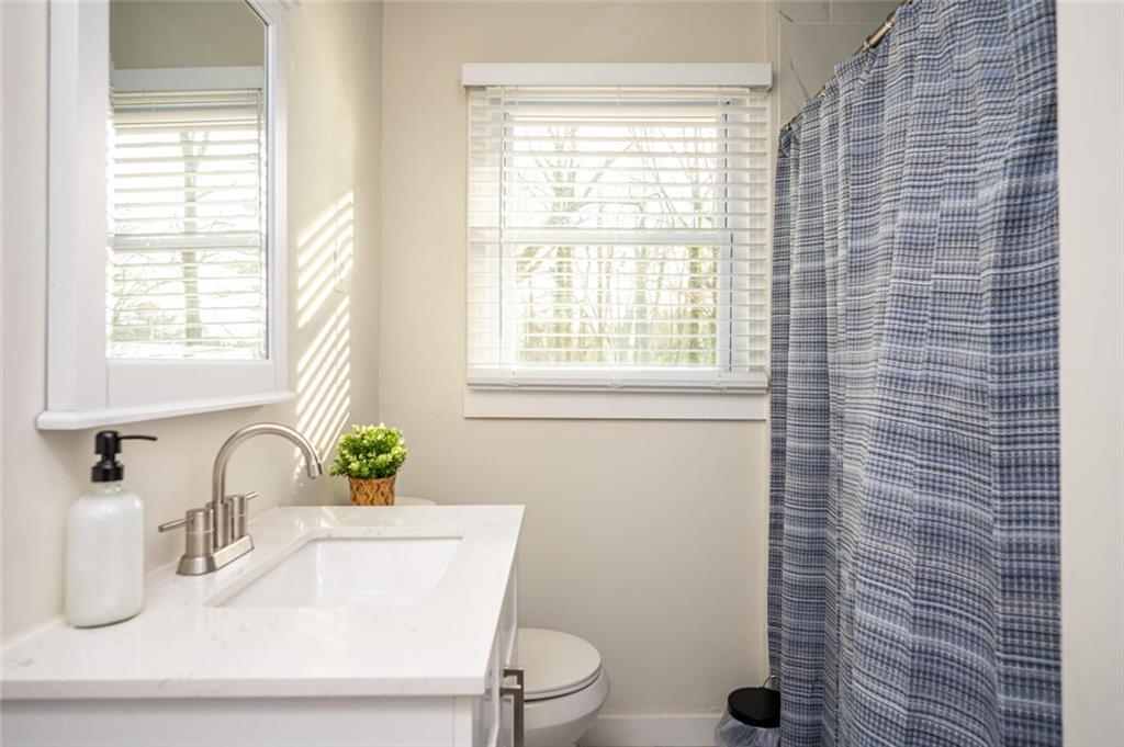 3154 Oakcliff Road Northwest Atlanta, GA 30311 - Photo 25 of 41 a bathroom with a sink a toilet and a window
