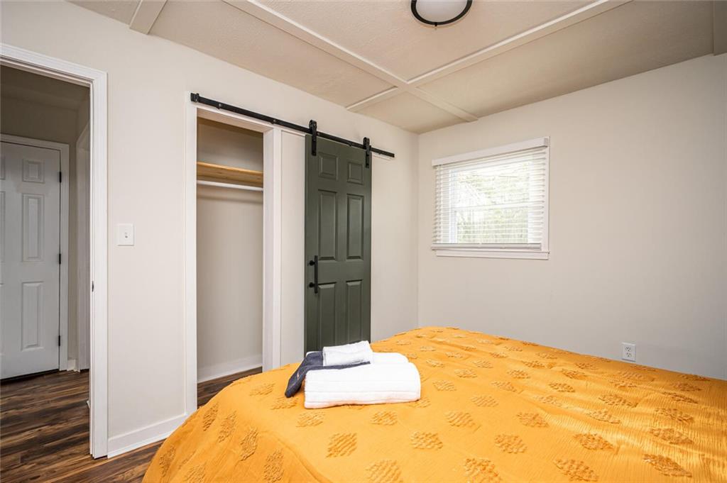 3154 Oakcliff Road Northwest Atlanta, GA 30311 - Photo 27 of 41 a bedroom with a bed and wooden floor
