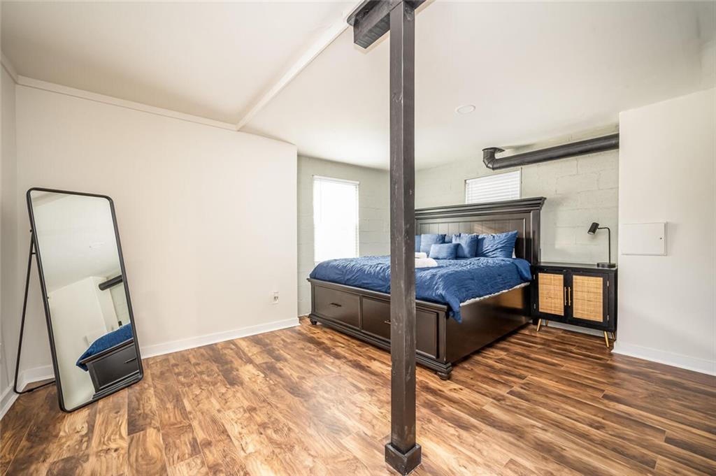 3154 Oakcliff Road Northwest Atlanta, GA 30311 - Photo 32 of 41 a bedroom with a bed and wooden floor