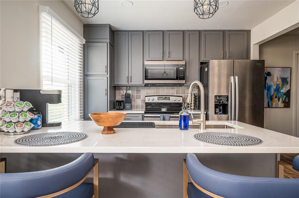 3154 Oakcliff Road Northwest Atlanta, GA 30311 - Photo 9 of 41 a kitchen with stainless steel appliances granite countertop a sink a stove and a refrigerator