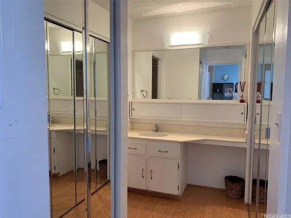 a bathroom with a shower sink and mirror