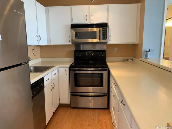 a kitchen with granite countertop a stove and a microwave