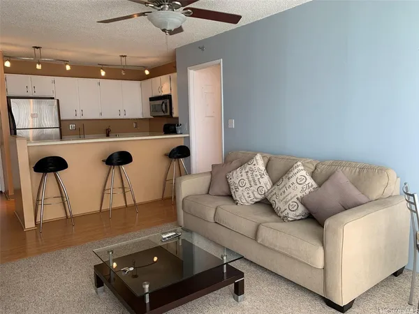 a living room with furniture and a chandelier