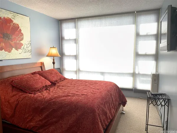 a bedroom with a bed and window