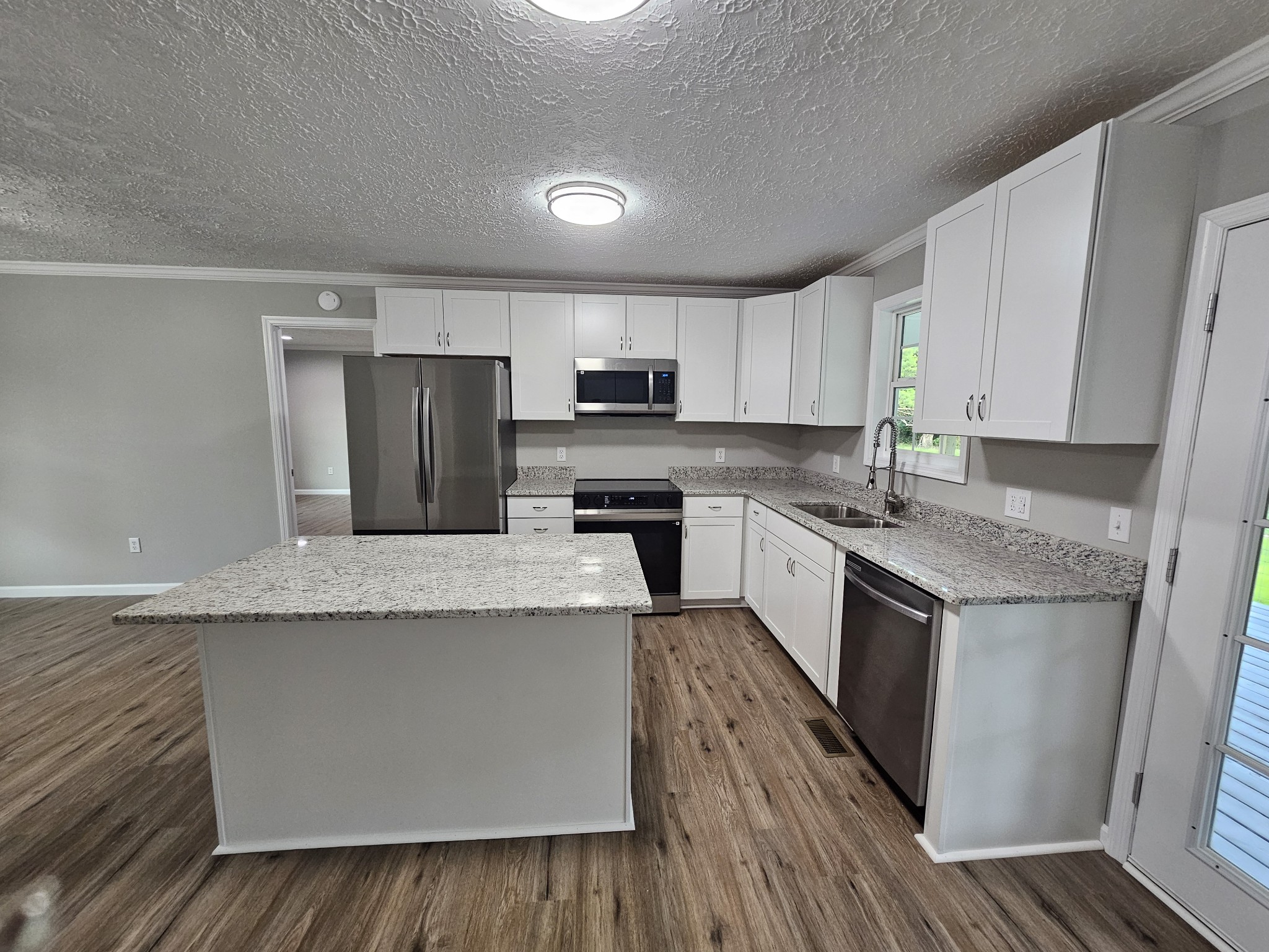 362 Forest Point Road Monteagle, TN 37356 - Photo 24 of 42 a kitchen with granite countertop a sink stove top oven and refrigerator