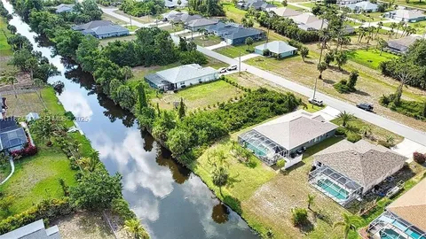 an aerial view of a house with a yard basket ball court and outdoor seating