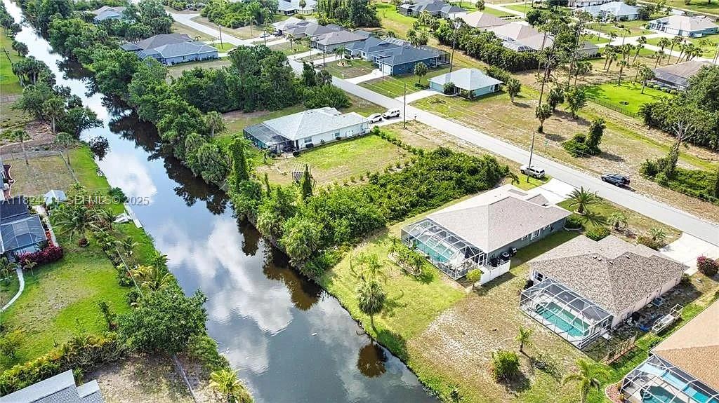 an aerial view of a house with a yard basket ball court and outdoor seating
