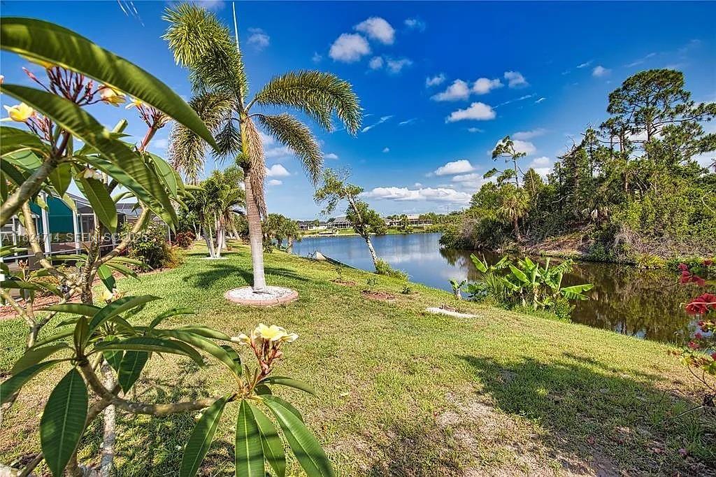150 Albatross Road Rotonda West, FL 33947 - Photo 3 of 7 a backyard of a house with lots of green space