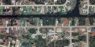 150 Albatross Road Rotonda West, FL 33947 - Photo 7 of 7 a view of a lake with a building in front of it