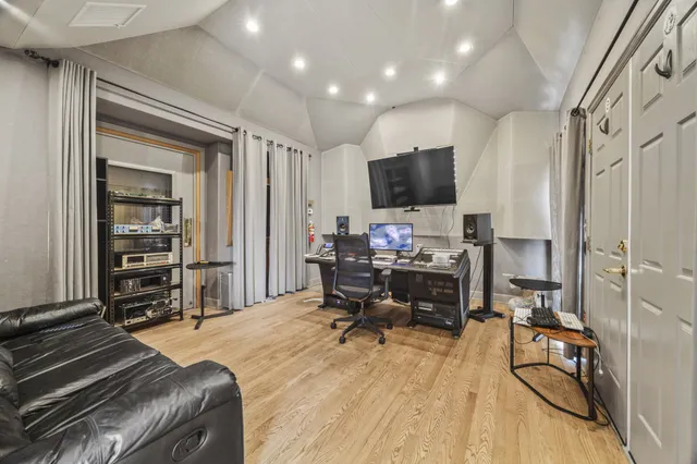a living room with furniture a flat screen tv and a window
