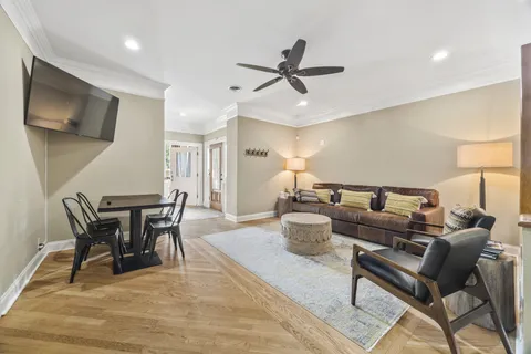 a kitchen with stainless steel appliances granite countertop a sink stove refrigerator and white cabinets with wooden floor