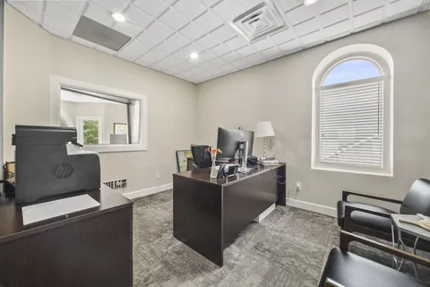 a dining room with furniture and window
