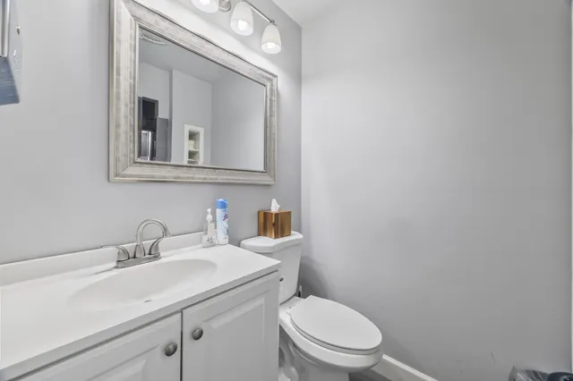 a view of staircase with railing and a painting on the wall