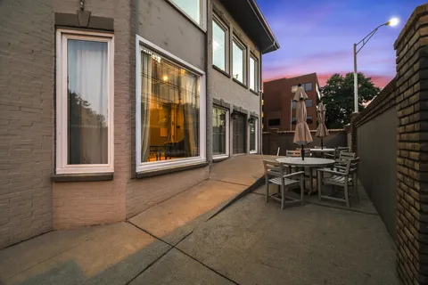 a view of a brick house with large windows