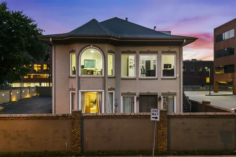 a view of a hallway with wooden floor and a living room
