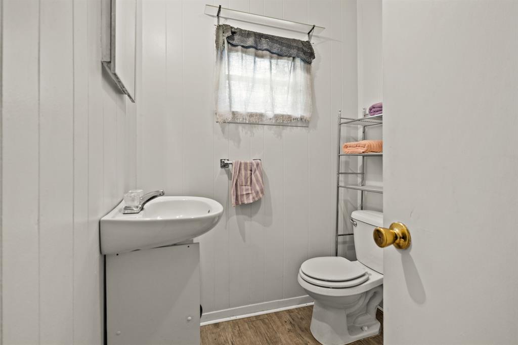 103 South Sun Camp Road White Oak, TX 75693 - Photo 20 of 40 a bathroom with a sink mirror vanity and toilet