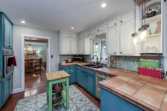 a kitchen with a sink stove and cabinets