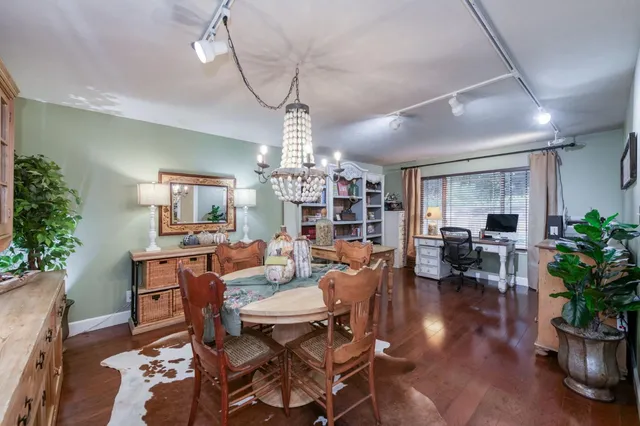 a living room with fireplace furniture and a potted plant