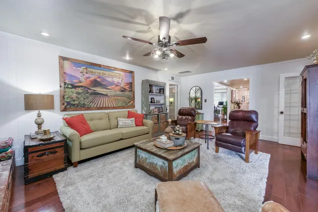 a living room with furniture a rug and a lamp