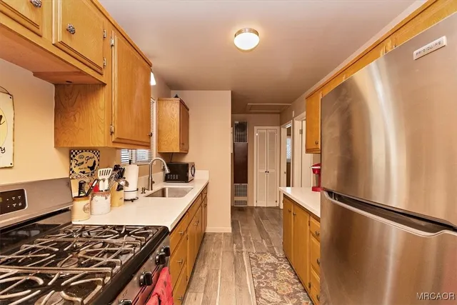a kitchen with sink a stove and refrigerator