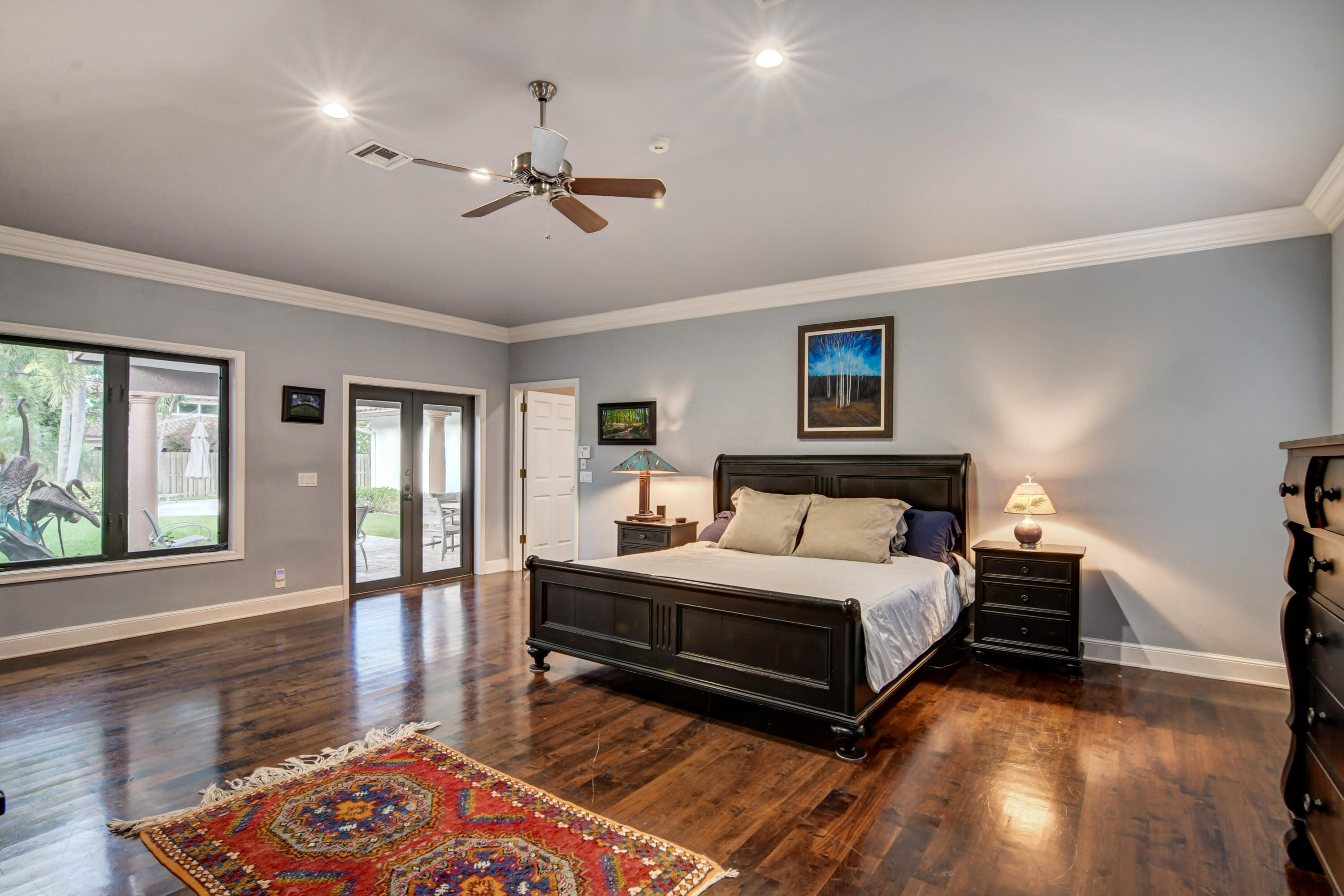 921 Southwest 20th Street Boca Raton, FL 33486 - Photo 25 of 56 a bedroom with a bed lamps and wooden floor