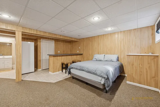 a spacious bedroom with a bed and a cabinets