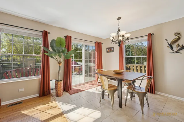 a view of a dining room with furniture wooden floor and chandelier