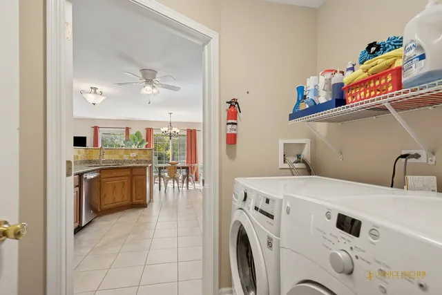 a view of washer and dryer with kitchen in the background