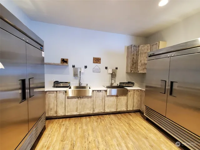 a kitchen with stainless steel appliances granite countertop a sink and cabinets