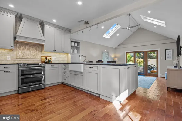 a kitchen with a cabinets and wooden floor