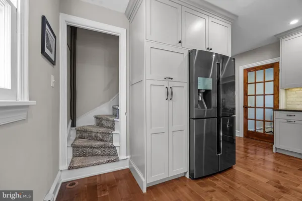 a view of a kitchen with wooden floor and electronic appliances