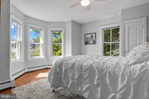 a bed sitting in a bedroom next to a window