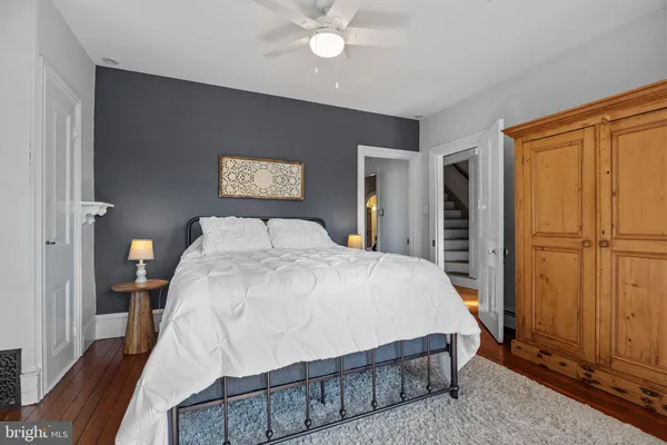 a bed sitting in a bedroom next to a window