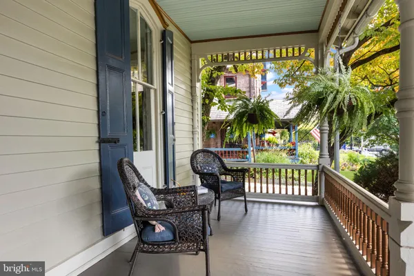 a view of a chairs and table in the balcony