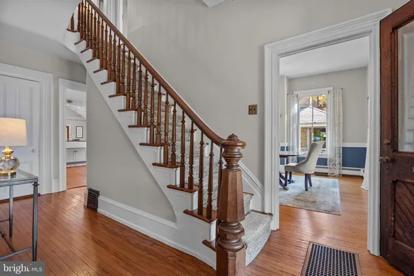 a view of entryway and hall with wooden floor