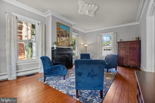 a living room with furniture a fireplace and a window