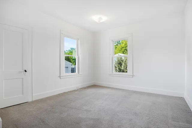 a view of room with window and bed