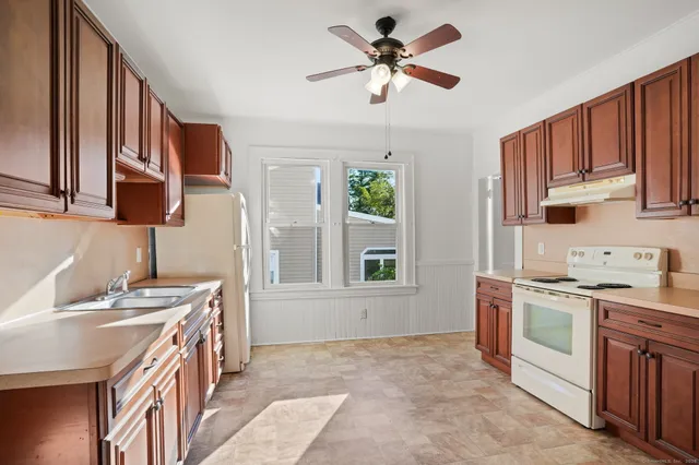 a kitchen with a sink stove and microwave