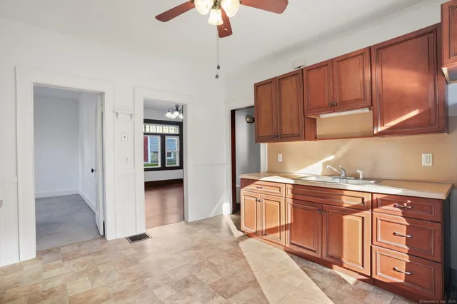 a kitchen with stainless steel appliances granite countertop a refrigerator and a sink