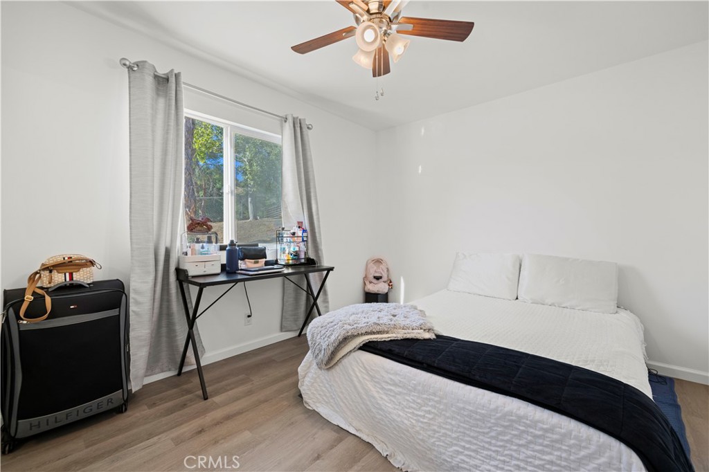 3855 Acton Avenue Acton, CA 93510 - Photo 11 of 21 a bedroom with a bed and a chandelier